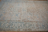 Geometric floral field and distinct Turtle Samovar border of a distressed Mehrivan rug.