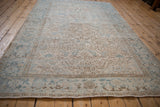 Distressed Mehrivan rug border and geometric field with blue, ivory, and coffee brown abrashes.