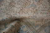 Distressed Mehrivan rug close-up, highlighting geometric blue and beige pattern texture.