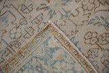 Distressed Mehrivan carpet with geometric ivory, blue pattern, hand-knotted back, and selvage.
