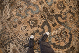 The worn, low-pile texture of a vintage distressed Khoy carpet shown underfoot for scale and context.
