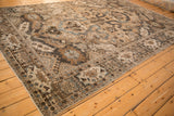 Vintage Khoy carpet's heavily abrashed ground and cloudband motifs viewed from an angle.