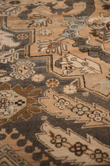Abrashed texture and geometric cartouche details on a vintage distressed Persian Khoy rug.