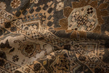 Softly draped vintage Khoy rug showing abrashed charcoal and sand tones within its geometric cartouche pattern.