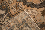 Folded corner of a vintage Khoy rug showing its woven foundation and secure machine-bound side.