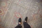A close view of the low, hand-knotted pile with mostly even wear on a silver Pakistani rug.
