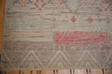 Hand-knotted pile showing mostly even wear across knot heads with primitive geometric patterns.