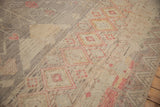 Close-up of primitive diamond motifs in red and yellow on the rug's silver hand-knotted pile.