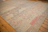 Angled view showing the low, hand-knotted pile and mostly even wear of the carpet.