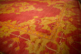 Angled view of the corner spandrel and border on a hand-knotted antique Oushak carpet.