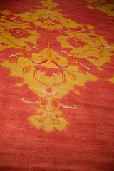 Hand-knotted texture of saffron yellow quatrefoil medallions on an antique Oushak's red pile.