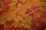 Detailed texture of the short pile on an antique Oushak in cochineal red and saffron yellow.