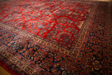 Rich cherry red and sapphire blue tones on the soft, even pile of a vintage Persian Kazvin carpet.