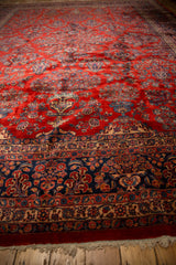 View across the repeating floral potted plant design on a plush red vintage Kazvin carpet.
