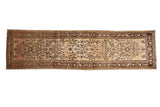A vintage Bibikabad runner with a distressed floral design in sandy beige, soft pink, and chocolate brown.
