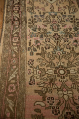 Close view of the meandering floral vine border and distressed, low pile of the vintage runner.