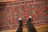 Even pile and detailed floral sprays on a cherry red vintage Sarouk Persian runner.