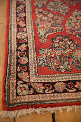 Detailed view of the Persian Sarouk runner's corner, showing the intact side cord selvage and floral border.