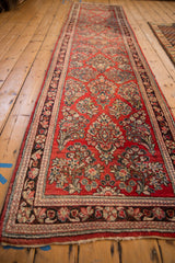 A long view down a vintage Sarouk runner showing the lattice orientation of its floral bouquets.