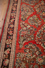 Angled view of the vintage Sarouk runner's even pile and intricate floral border.