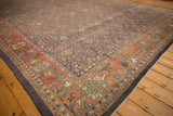 Distressed Persian Mahal carpet corner, charcoal field's lattice pattern and terracotta lotus vine border.