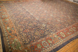 Distressed Mahal carpet detail with terracotta lotus blossom border, charcoal henna field.