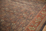 Close-up showing a distressed Mahal carpet, charcoal field, palmette motifs, and worn cherry red border.