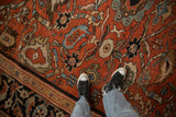 Close view of an antique Sultanabad's expressive paisley blossoms and partial Herati border.