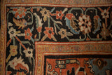 Expressive scrolled blossoms and vines in the Herati motif border of an antique Sultanabad carpet.