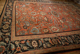 Intricate Herati motif border beside the scrolled paisley field of an antique Sultanabad carpet.