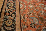 Close-up of the antique Sultanabad's charcoal border and madder red field with polychromatic vines.