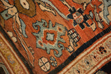 Checkered fruit motifs and visible knot heads on an antique Persian Sultanabad carpet.