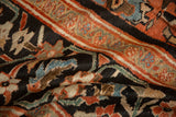 Richly colored paisley and vine motifs on the hand-knotted charcoal pile of an antique Sultanabad.