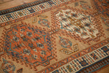 Close-up on the interconnected medallions with inverted ground coloration on an antique Serab runner.