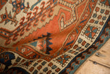 Angled detail of a Persian Serab runner's dense wool pile and reciprocating pawn border.