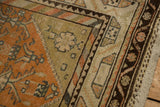 Colorful barber pole border and low, distressed pile on the corner of a vintage Malayer rug.