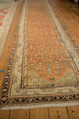 Angled view of a vintage Malayer runner showing its full length and repeating geometric pattern.