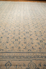 Low-angle view of the distressed texture and blue Herati motifs on a vintage Mahal rug.