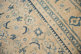 The low, hand-knotted pile of a distressed Mahal showing blue Herati motifs on an ivory field.