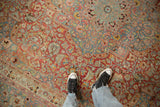 Distressed vintage Meshed carpet with intricate floral vines in cherry red and slate blue.