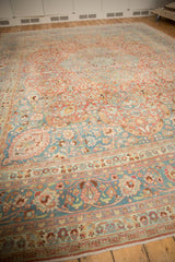 Vintage Distressed Meshed carpet detail with sprawling floral vines, cloudbands, and borders in blue and blush.
