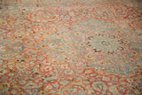 Distressed Meshed carpet detail: faded red field, powder blue vines, and exposed knot heads.