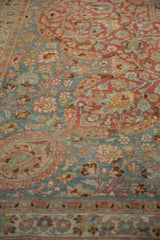 Distressed Meshed carpet with intricate sprawling vines in cherry red and pale blue.
