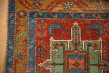 Corner of an antique Heriz runner showing the serrated leaf border and geometric wool pile.