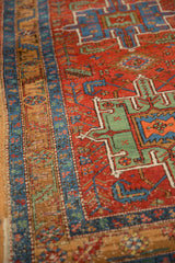 Close view of the side selvage and low pile on an antique Heriz rug with geometric borders.