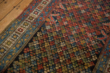 Detailed view of a vintage Hamadan rug's colorful lattice field and intricate teal and white border.