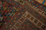 The hand-knotted back and colorful floral pile of a vintage Kurdish Hamadan runner.