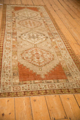 A long perspective view of the distressed Serab runner's repeating geometric pattern and earthy colors.