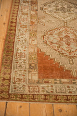 Angled corner of a distressed Serab runner with a pawn design motif and stepped medallion.