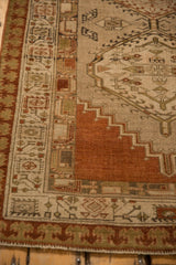 Corner view of a vintage Serab rug highlighting the pawn motif border and stepped terracotta medallion.